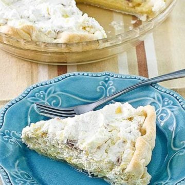 Homemade Furr's Pineapple Millionaire Pie on a blue plate next to the pie